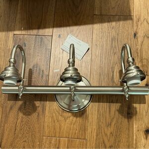 Brunswick 3 light 24” satin nickel bathroom vanity wall light by Savoy House